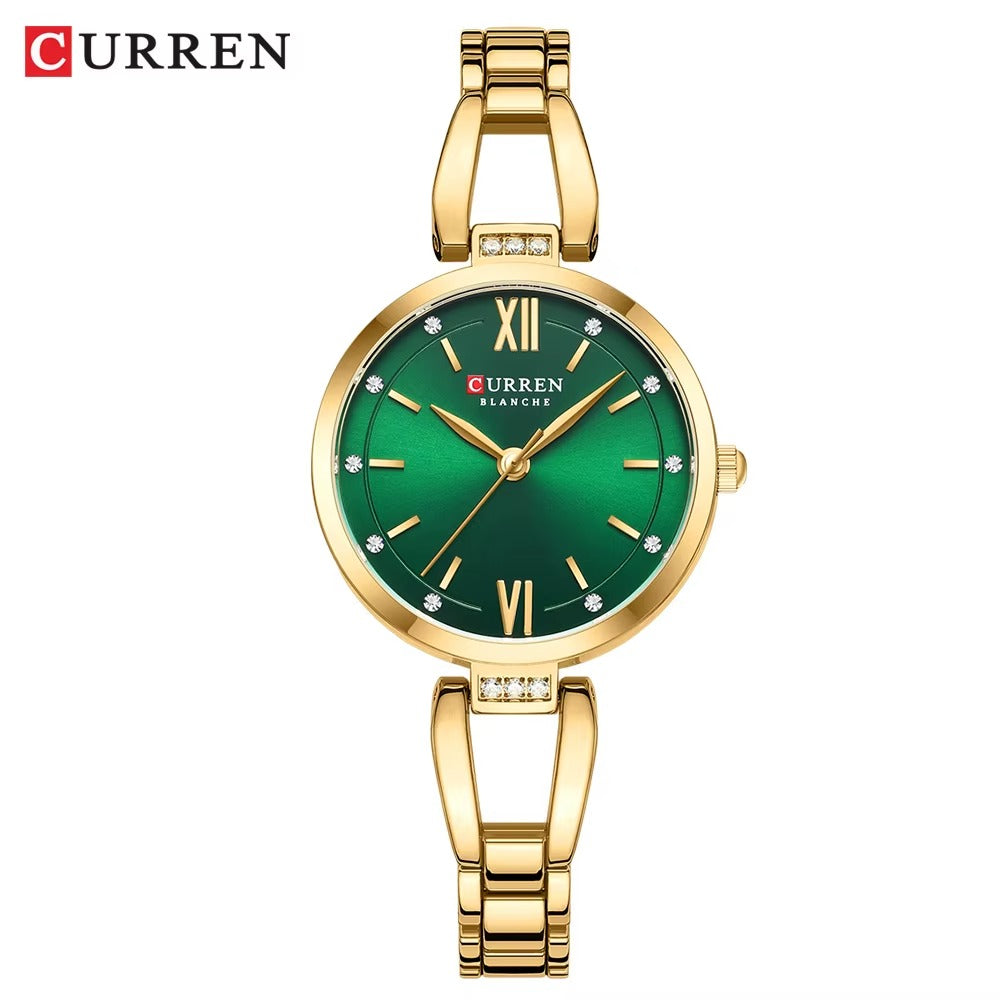 Silver women’s Curren Blanche wristwatch with green dial, gold hour markers, and stainless steel bracelet on white background.