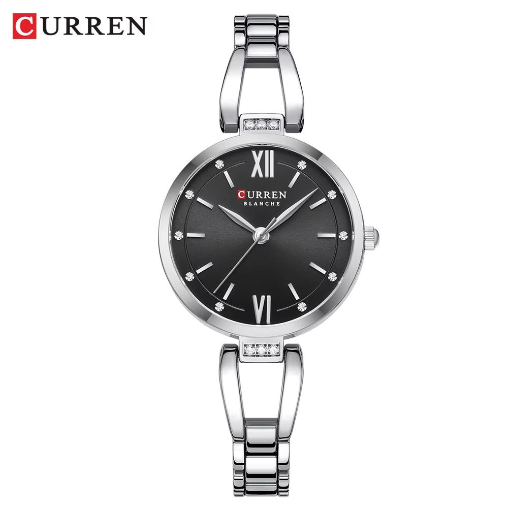 Silver women’s Curren Blanche wristwatch with black dial, crystal hour markers, and stainless steel bracelet on white background.