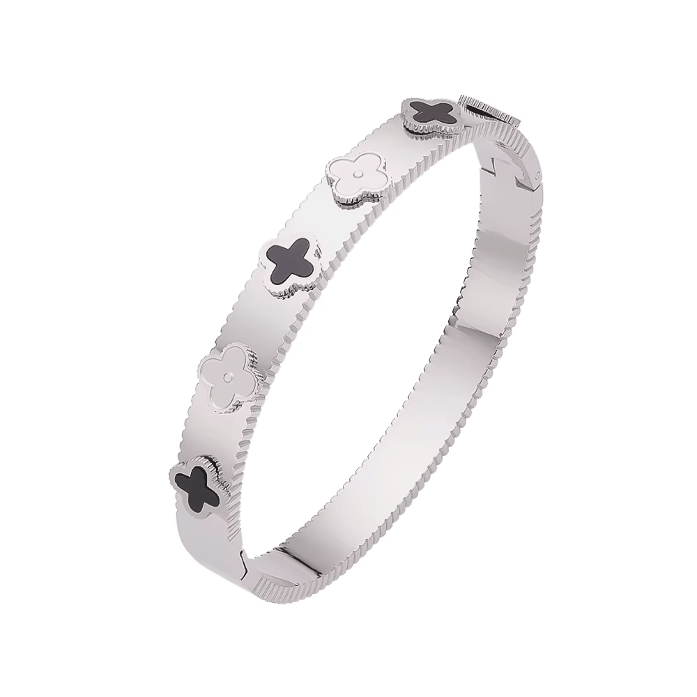 Luxury clover motif bangle bracelet in silver finish with alternating black and solid silver clover designs.