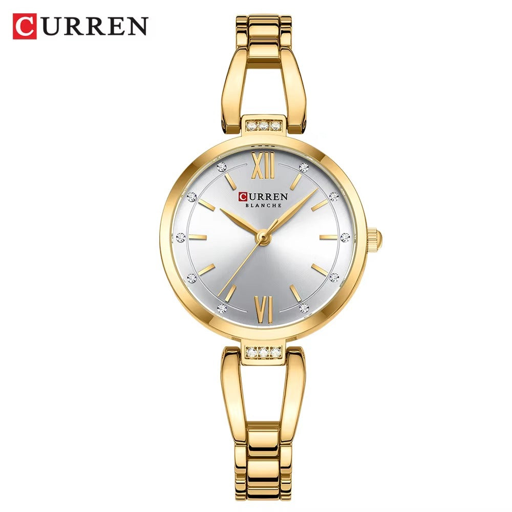 Gold Curren watch with a white face on a white background